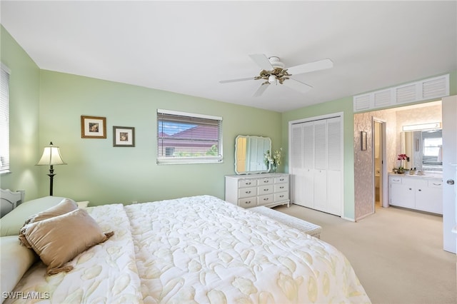 bedroom featuring ceiling fan, a closet, and light colored carpet