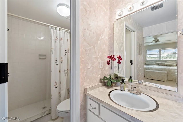 bathroom featuring ceiling fan, curtained shower, vanity, and toilet