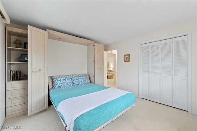 bedroom featuring light colored carpet and a closet