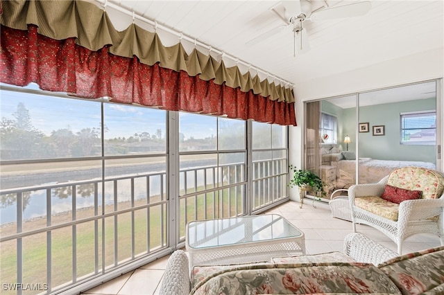 sunroom / solarium featuring ceiling fan and plenty of natural light