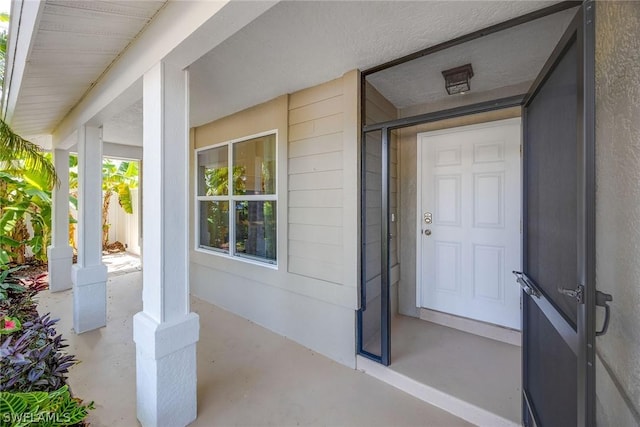 view of exterior entry featuring a porch