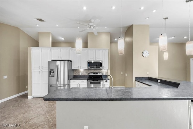 kitchen featuring white cabinetry, decorative light fixtures, appliances with stainless steel finishes, kitchen peninsula, and decorative backsplash