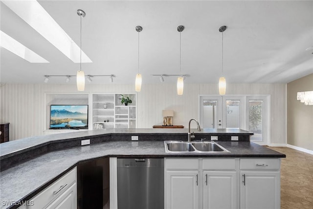 kitchen with dishwasher, sink, pendant lighting, and white cabinets