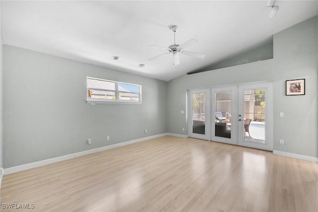 spare room featuring french doors, ceiling fan, vaulted ceiling, and light hardwood / wood-style flooring