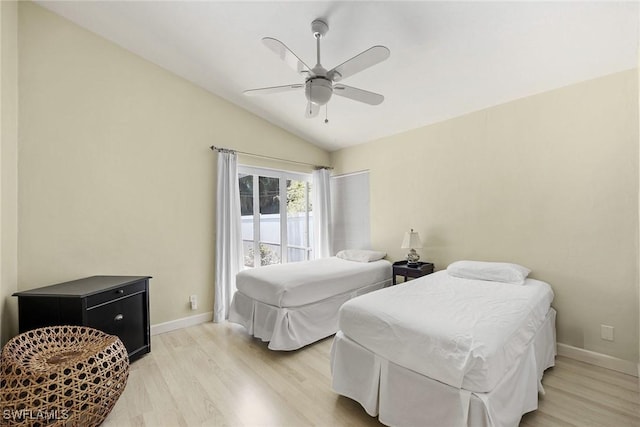 bedroom featuring ceiling fan, lofted ceiling, and light hardwood / wood-style flooring