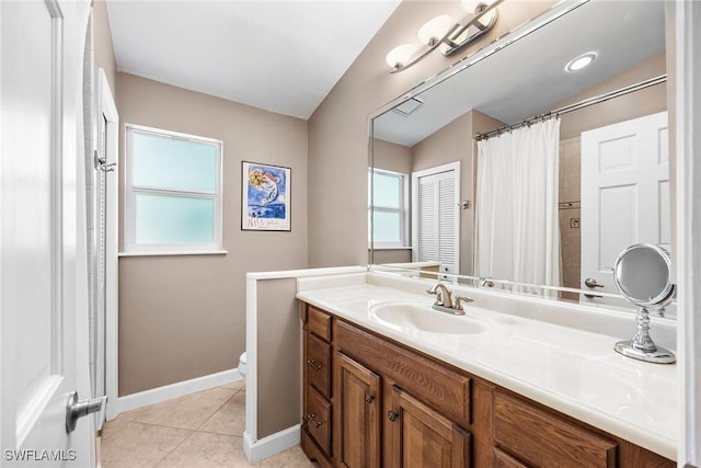 bathroom featuring tile patterned flooring, vanity, and toilet