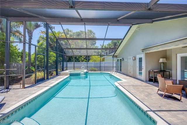 view of swimming pool featuring an in ground hot tub, glass enclosure, a bar, and a patio