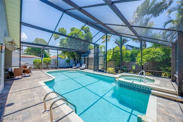 view of swimming pool featuring a lanai, a patio area, and an in ground hot tub