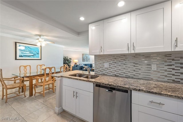 kitchen featuring light stone counters, white cabinetry, a sink, dishwasher, and backsplash