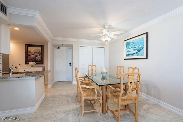 dining space with visible vents, baseboards, a ceiling fan, and crown molding