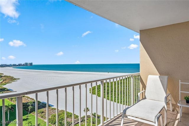 balcony with a beach view and a water view