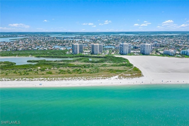 birds eye view of property featuring a water view, a city view, and a view of the beach