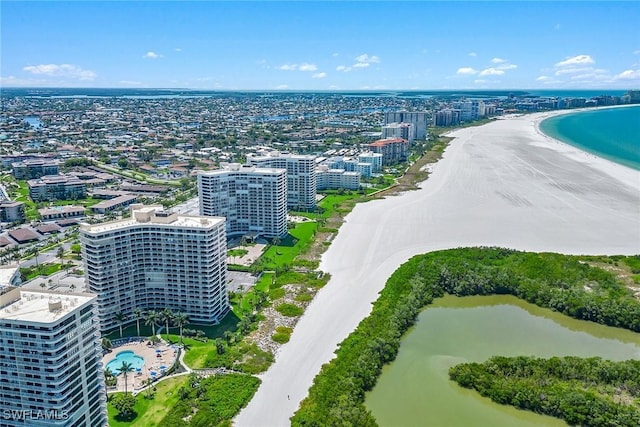 birds eye view of property featuring a water view, a city view, and a beach view