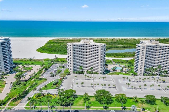 birds eye view of property featuring a view of the beach and a water view