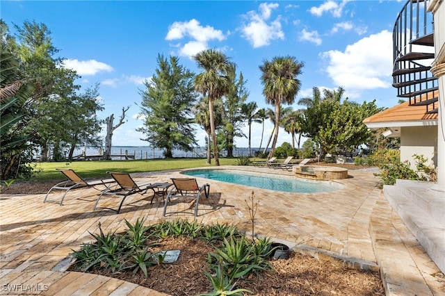 view of swimming pool featuring a water view and a patio area