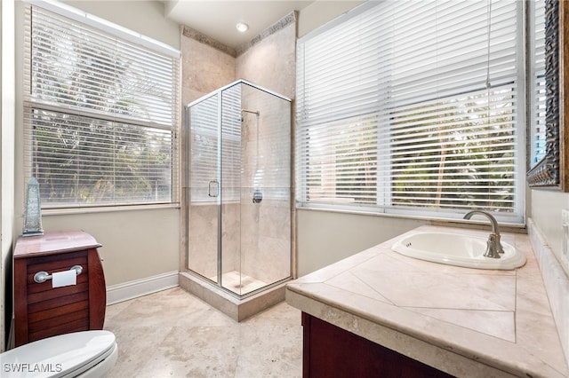 bathroom with walk in shower, vanity, and toilet