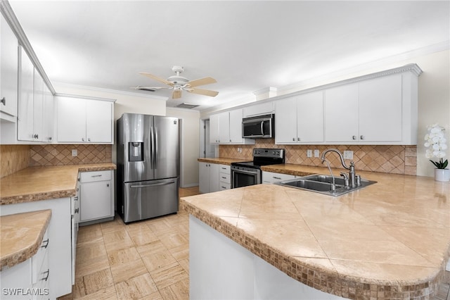 kitchen featuring white cabinetry, appliances with stainless steel finishes, kitchen peninsula, and sink