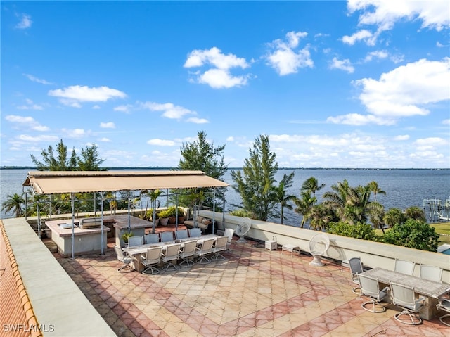 view of patio / terrace featuring a water view and an outdoor bar