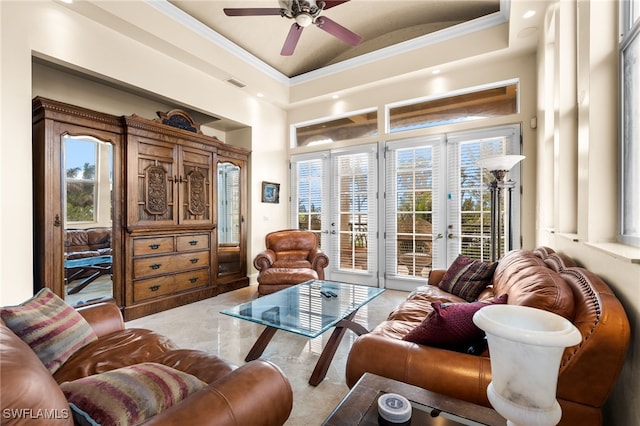 living room with crown molding, french doors, and a raised ceiling