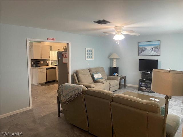 living room featuring ceiling fan, visible vents, and baseboards