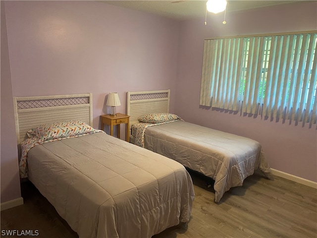 bedroom featuring wood-type flooring and ceiling fan