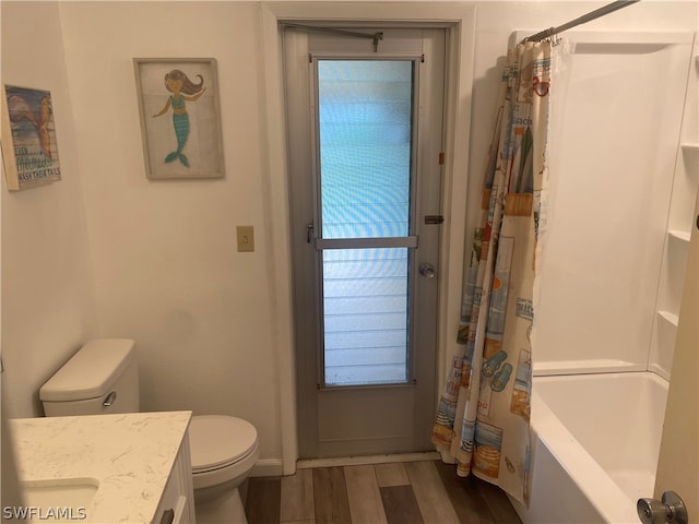 full bathroom with shower / bath combo, hardwood / wood-style flooring, toilet, and vanity