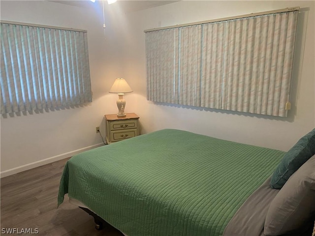 bedroom featuring baseboards and wood finished floors