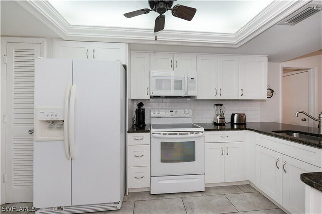 kitchen with white cabinetry, white appliances, sink, and dark stone counters