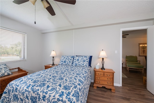 bedroom with ceiling fan, dark hardwood / wood-style floors, and a textured ceiling