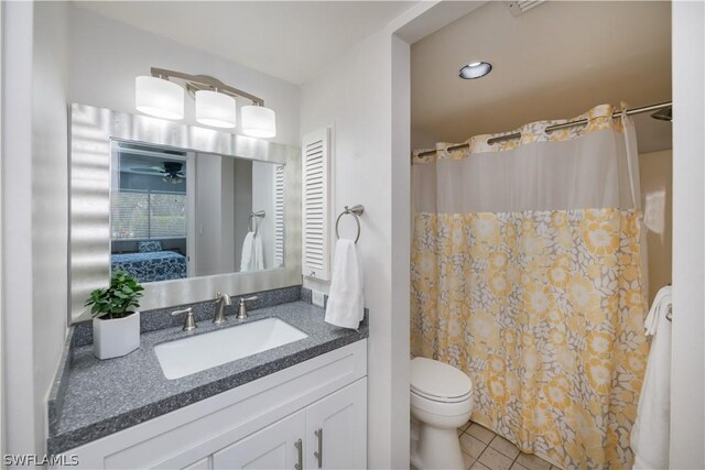 bathroom featuring vanity, a shower with curtain, tile patterned flooring, ceiling fan, and toilet