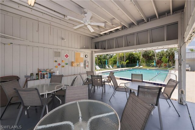 view of swimming pool with ceiling fan and a patio