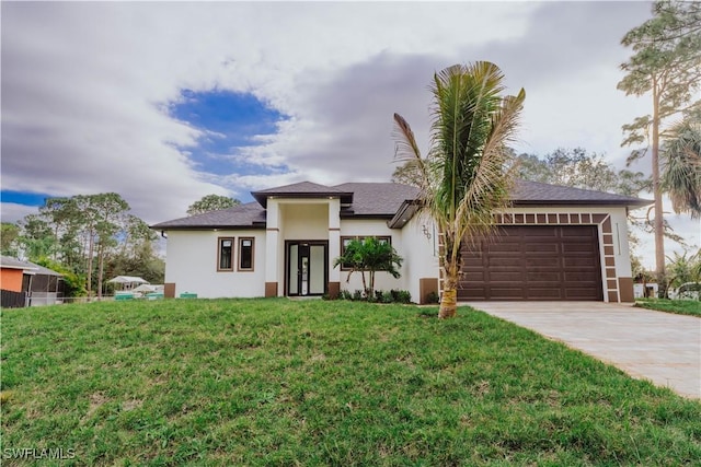 view of front of property featuring a front yard and a garage