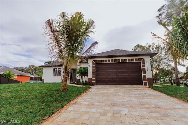 view of front facade with a garage and a front lawn