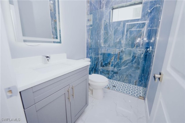 bathroom with vanity, a shower with shower door, and toilet