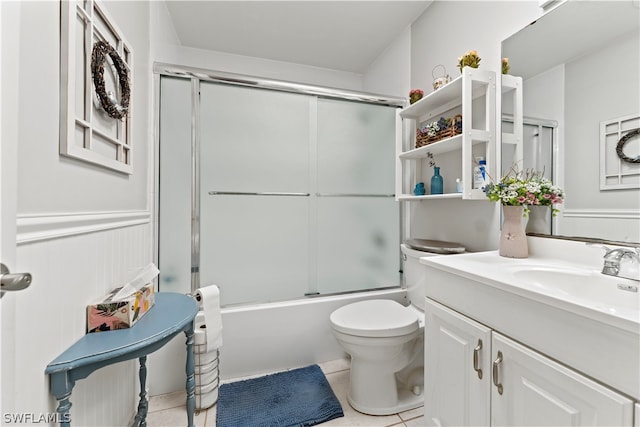 full bathroom with tile flooring, oversized vanity, bath / shower combo with glass door, and toilet