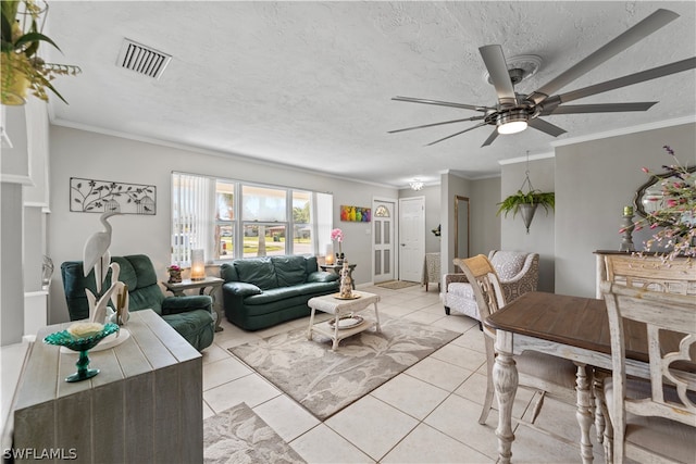 living room featuring ceiling fan, ornamental molding, and light tile floors