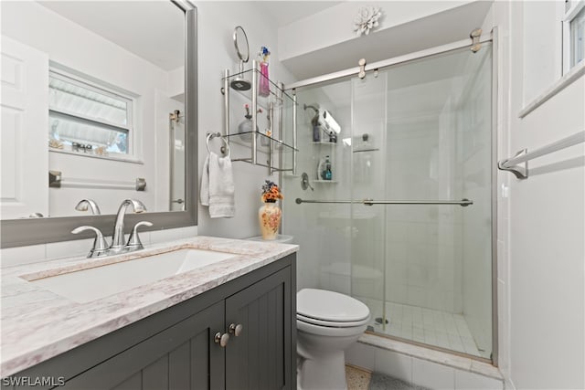 bathroom with walk in shower, oversized vanity, and toilet