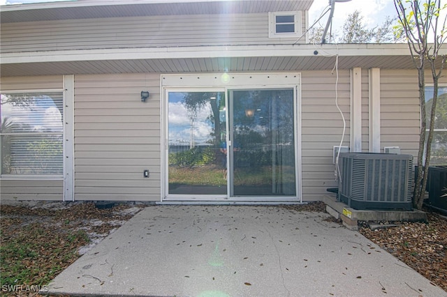 property entrance featuring central AC and a patio area