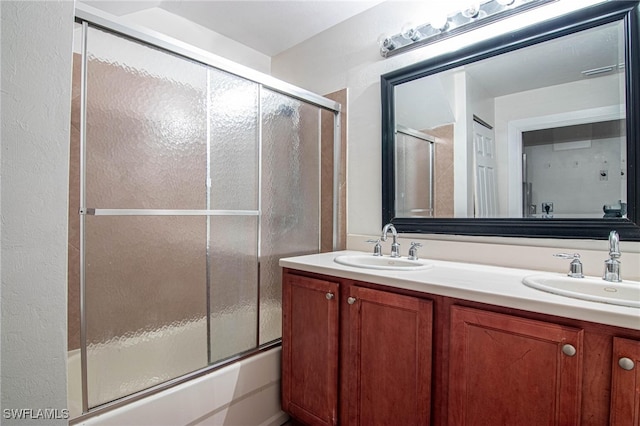 bathroom featuring shower / bath combination with glass door and vanity