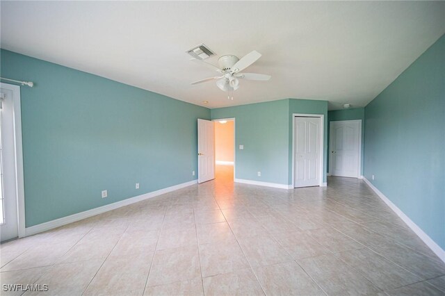 unfurnished bedroom featuring light tile patterned floors, a closet, and ceiling fan