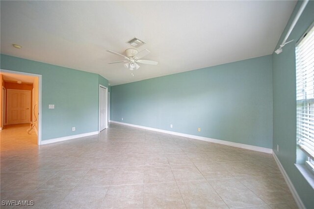 unfurnished room featuring light tile patterned floors and ceiling fan