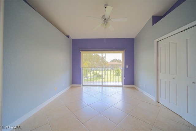 spare room with ceiling fan and light tile patterned floors