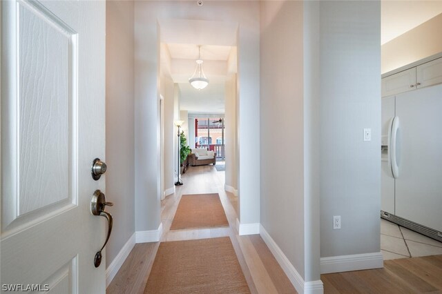 hall with light hardwood / wood-style floors