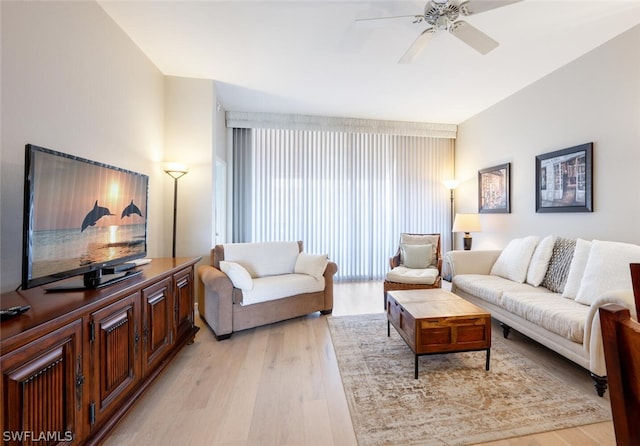 living room featuring ceiling fan and light hardwood / wood-style floors