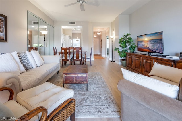 living room featuring light wood-type flooring and ceiling fan