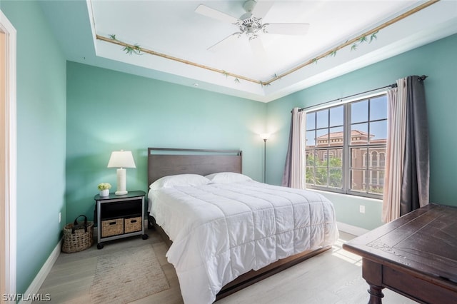 bedroom with ceiling fan and light hardwood / wood-style flooring