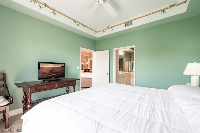 bedroom with hardwood / wood-style flooring and connected bathroom