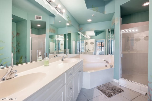 bathroom with tile patterned flooring, shower with separate bathtub, and vanity