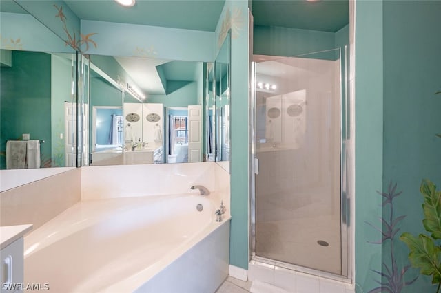 bathroom featuring separate shower and tub, vanity, and tile patterned flooring