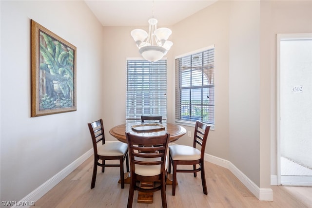 dining room with a notable chandelier and light hardwood / wood-style floors